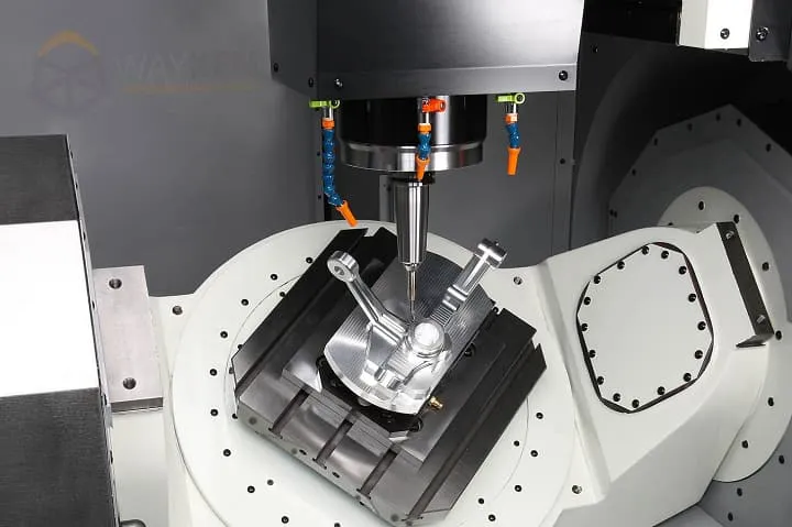 A metal component being machined in a CNC machining center